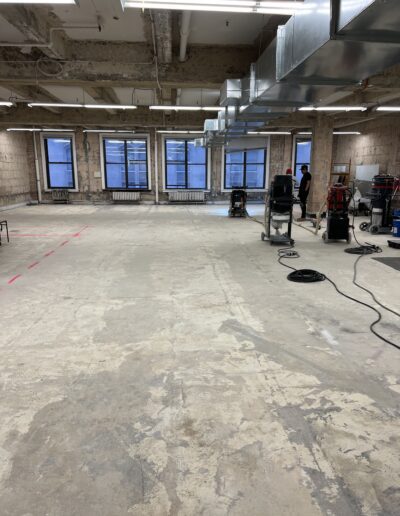 A long floor with cleaning machines positioned along it, ready for use