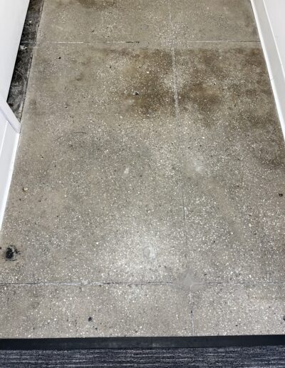 Image of a floor before cleaning, showing dirt and grime on the surface