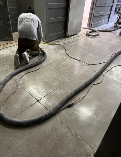 A man with a vacuum on the floor