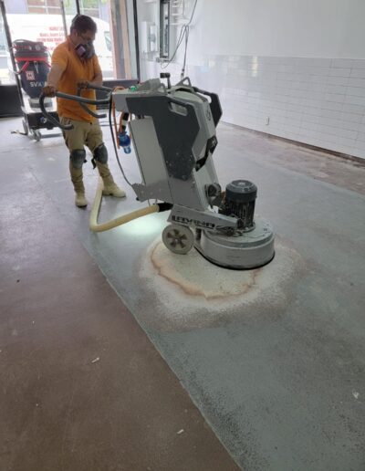 A man using a machine on a floor